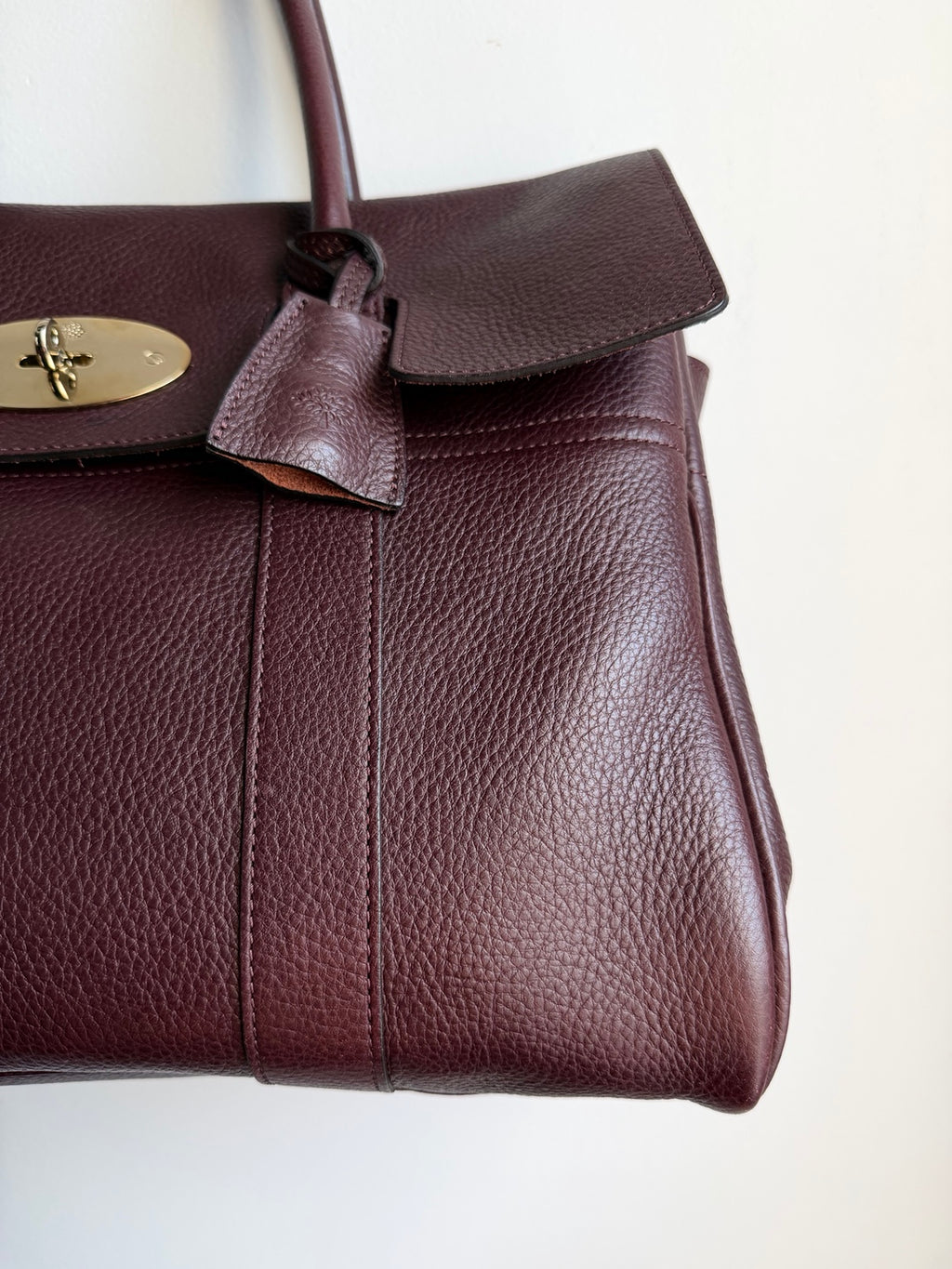 Close-up of pebbled leather and hanging clochette