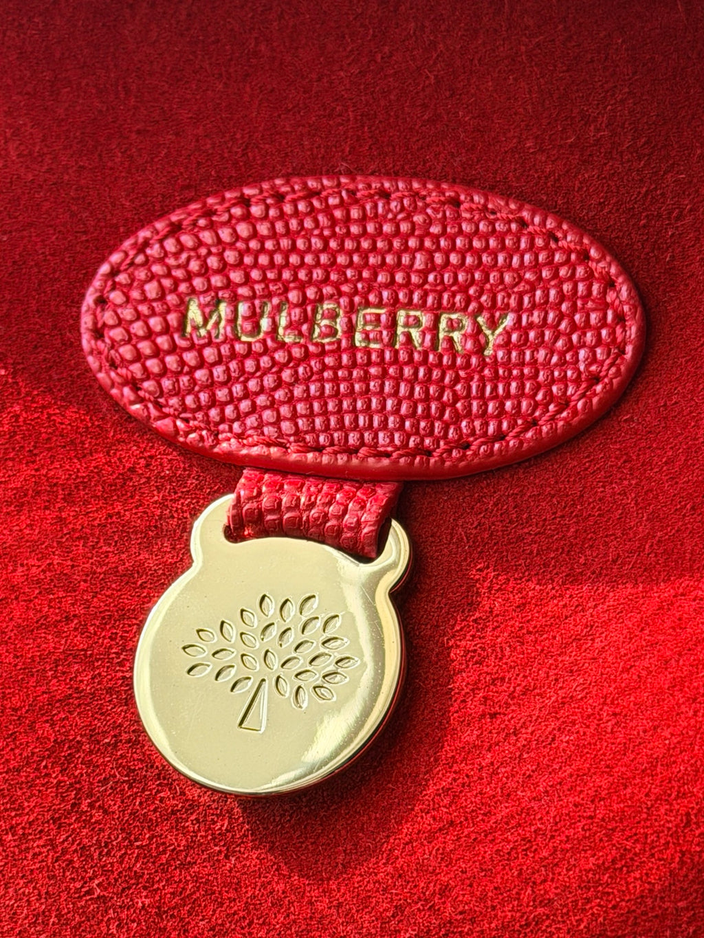 Mulberry embossed interior leather tag with gold-tone tree medallion